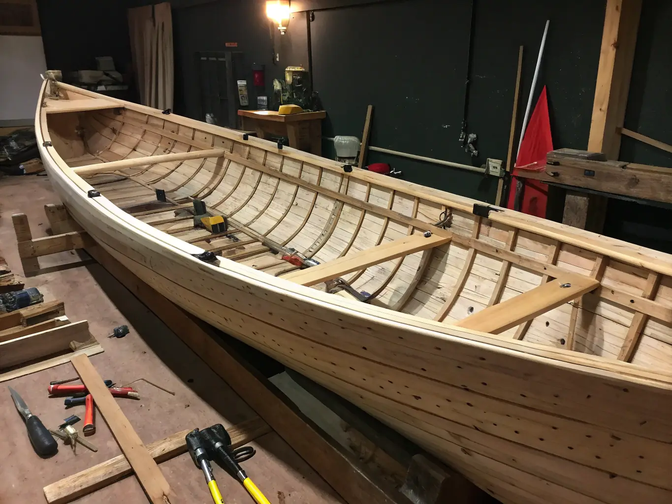 A craftsman carefully working on the wooden interior of a boat, showcasing the refurbishment and interior design services.